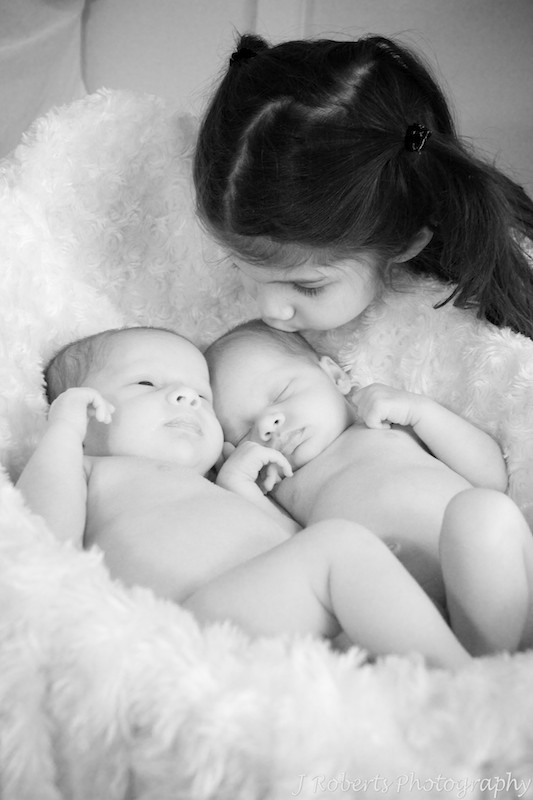 sister kissing twins in basket - baby portrait photography sydney